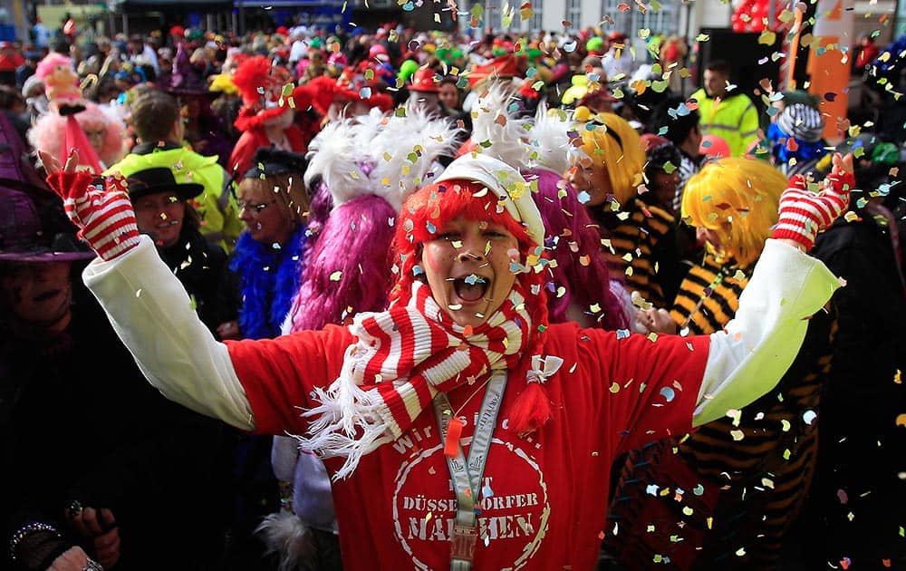 Revelers dressed in carnival costumes celebrate the start of the street-carnival with its tradition of entering the town halls and women cutting off men`s ties with scissors on carnival`s so called