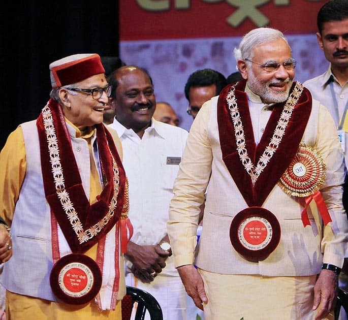 Bharatiya Janata Party (BJP)`s prime ministerial candidate Narendra Modi with senior BJP leader Murli Manohar Joshi during the Traders National Summit in New Delhi.