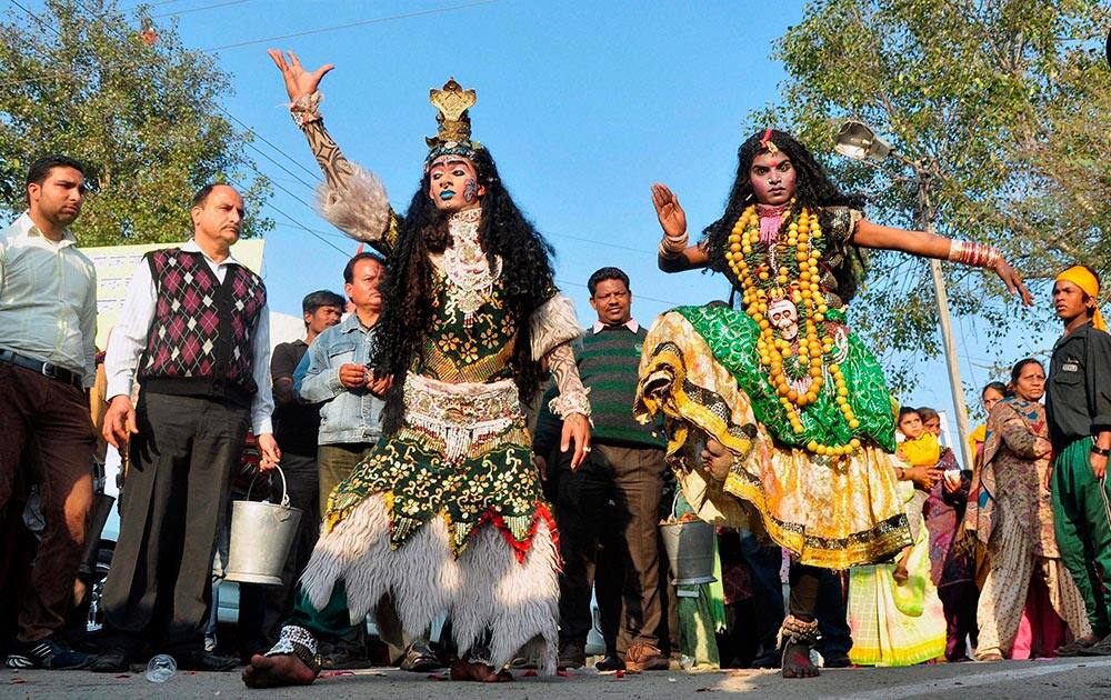 Devotees dressed as Lord Shiva and Goddess Kali take part in a Shobha Yatra on the eve of Maha Shivratri in Patiala.