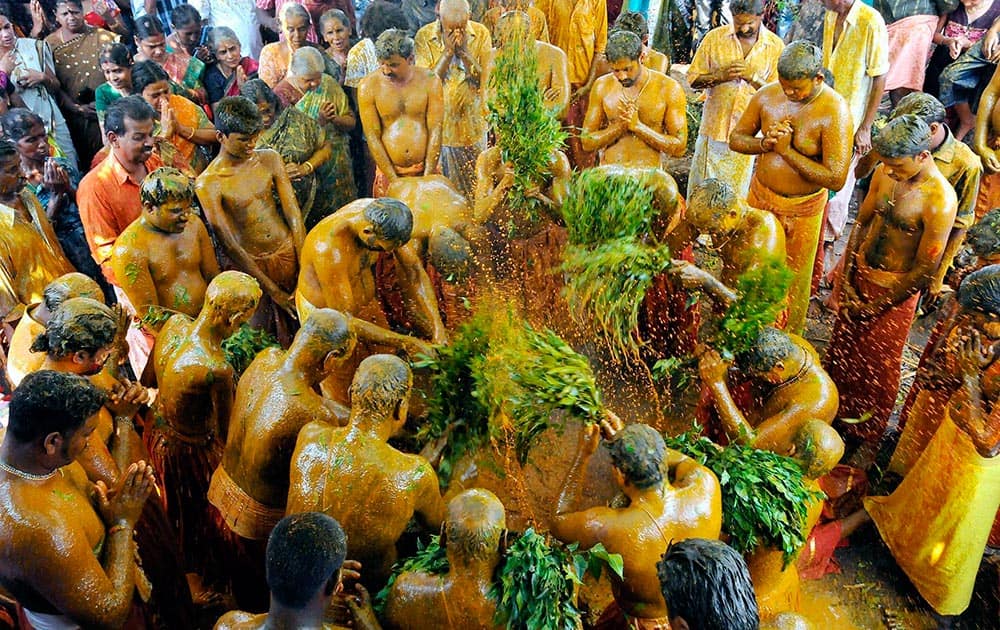 Devotees participate in ‘Manjaneeratu’ ritual as part of Ammankudam festival at Mariyamman temple in Kozhikode.