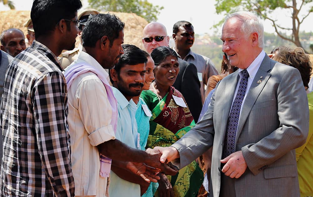 Canada’s Governor General David Johnston interacts with Indian farmers during his visit to University of Agricultural Sciences in Bangalore. Johnston arrived Saturday on a week-long official visit to India.