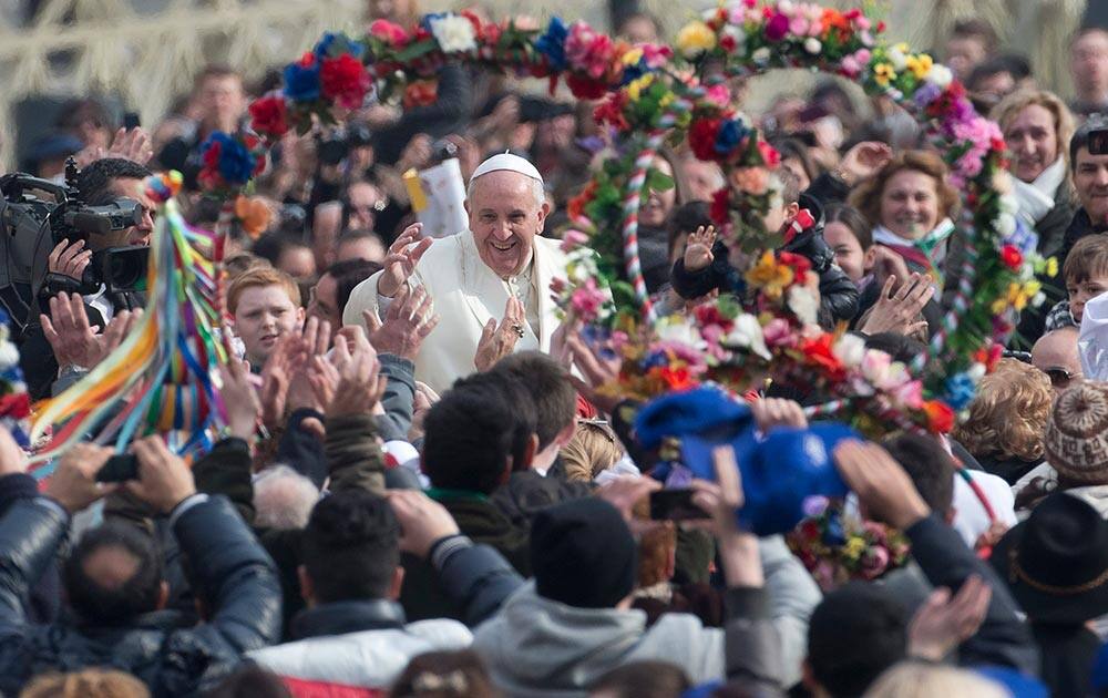 Pope Francis is cheered as he is driven through the crowd ahead of his weekly general audience in St. Peter`s Square, at the Vatican.