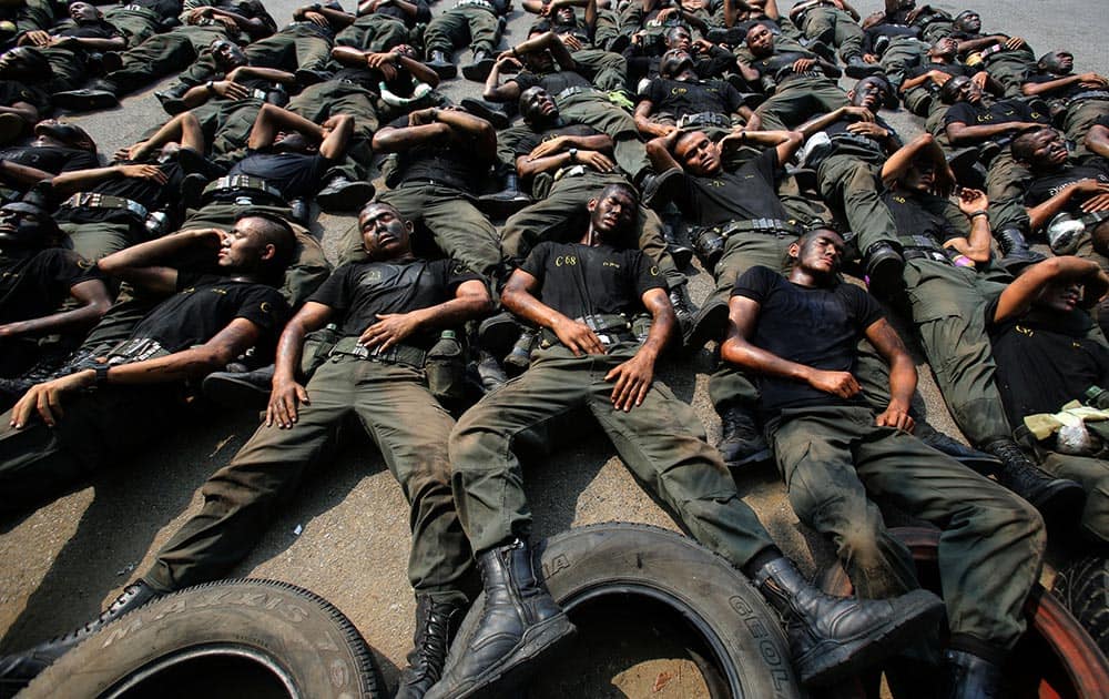 Thai police commandos take a rest during an anti terrorist exercise at Crime Suppression Division in Bangkok, Thailand.