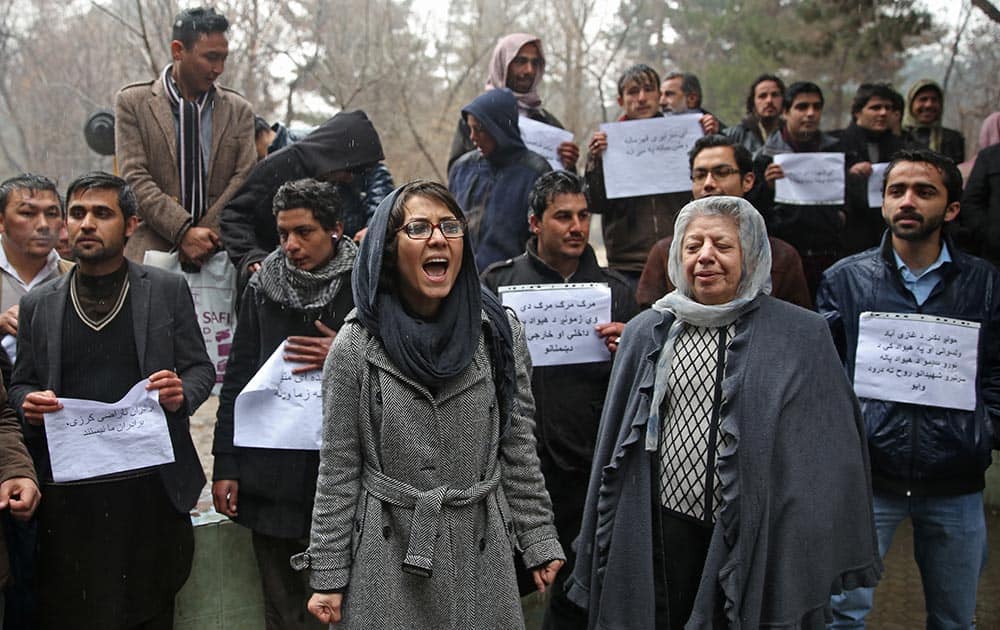 Afghan members of civil society organizations chant slogans to condemn the killing of over 20 Afghan National Army (ANA) soldiers, in a park in the Afghan capital Kabul, Afghanistan.