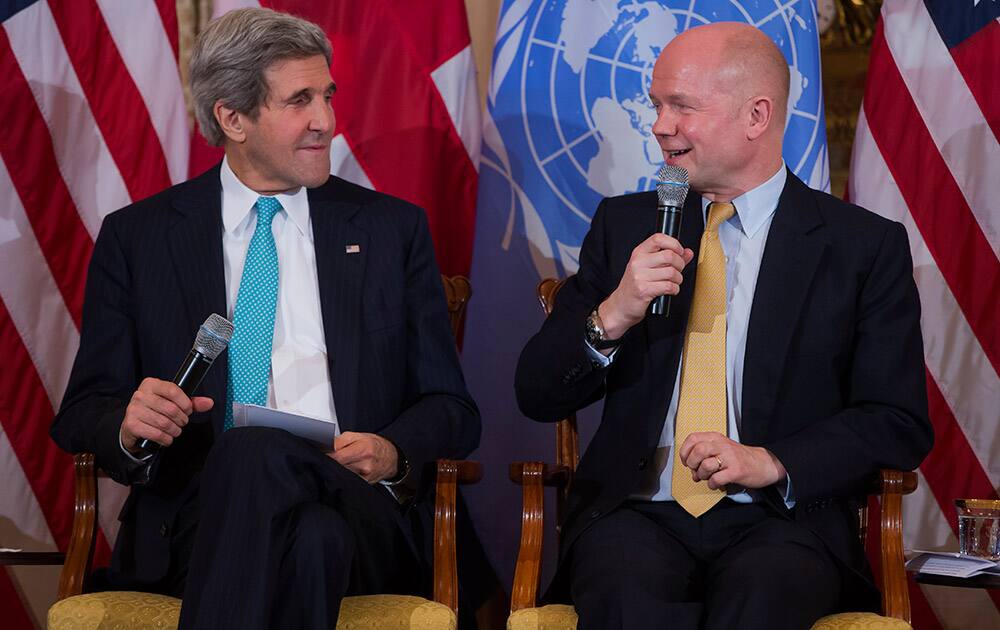 Secretary of State John Kerry listens as British Foreign Secretary William Hague speaks at the State Department in Washington, during a discussion on ending sexual violence and conflict in war.