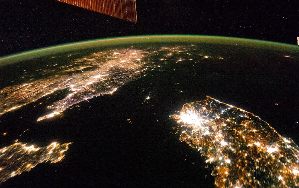 This Jan. 30, 2014 photo made available by NASA on Monday, Feb. 24, 2014 shows North Korea, darker area at center, between South Korea, right, and China, left. Lights from the North Korean capital, Pyongyang, are visible at center. The image comparing the night time lights of the countries was made by the Expedition 38 crew aboard the International Space Station.