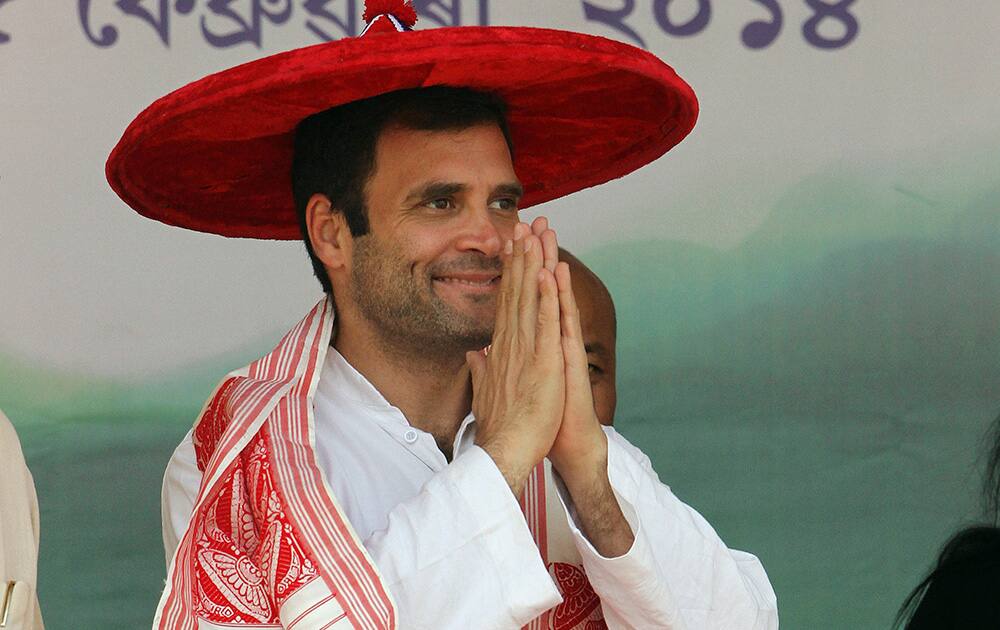 Rahul Gandhi wearing a traditional Assamese hat, Japi, greets the audience during a public rally in Guwahati.