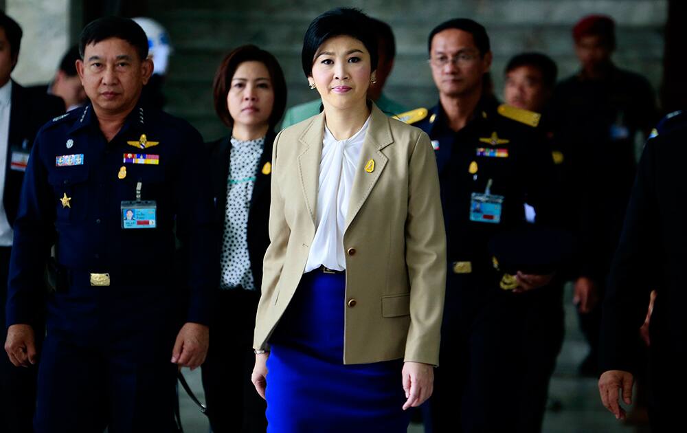 Prime Minister Yingluck Shinawatra leaves the Thai Air Force headquarters after a cabinet meeting in Bangkok, Thailand.