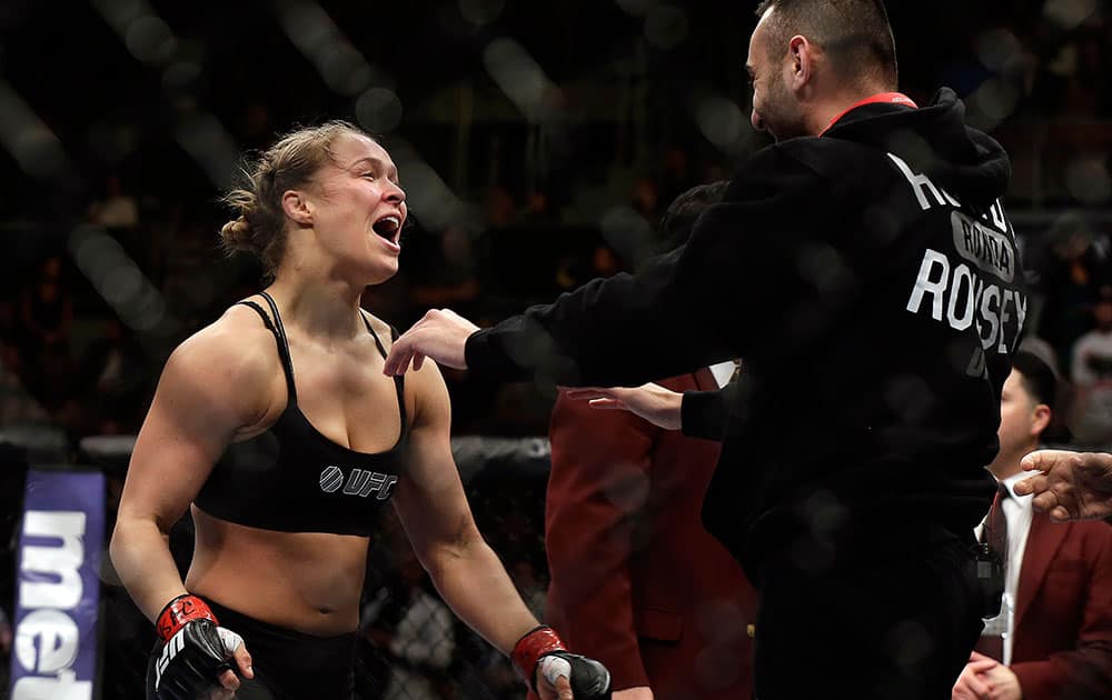 Ronda Rousey, left, goes to hug her trainer Edmond Tarverdyan after defeating Sara McMann in a UFC 170 mixed martial arts women`s bantamweight title fight.