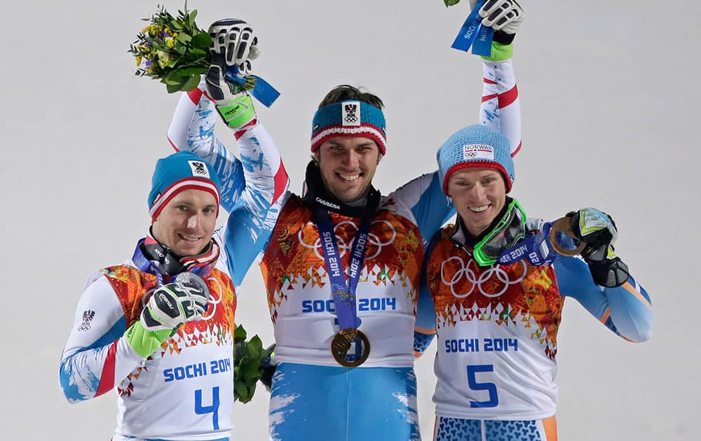 Men`s slalom winners Austria`s Mario Matt (gold), center, and his teammate Austria`s Marcel Hirscher (silver), left, celebrate on the podium with bronze medal winner, Norway`s Henrik Kristoffersen, right, at the Sochi 2014 Winter Olympics.