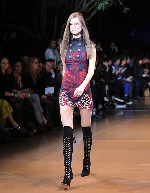 A model wears a creation for Versace women`s Fall-Winter 2014-15 collection, part of the Milan Fashion Week, unveiled in Milan, Italy.