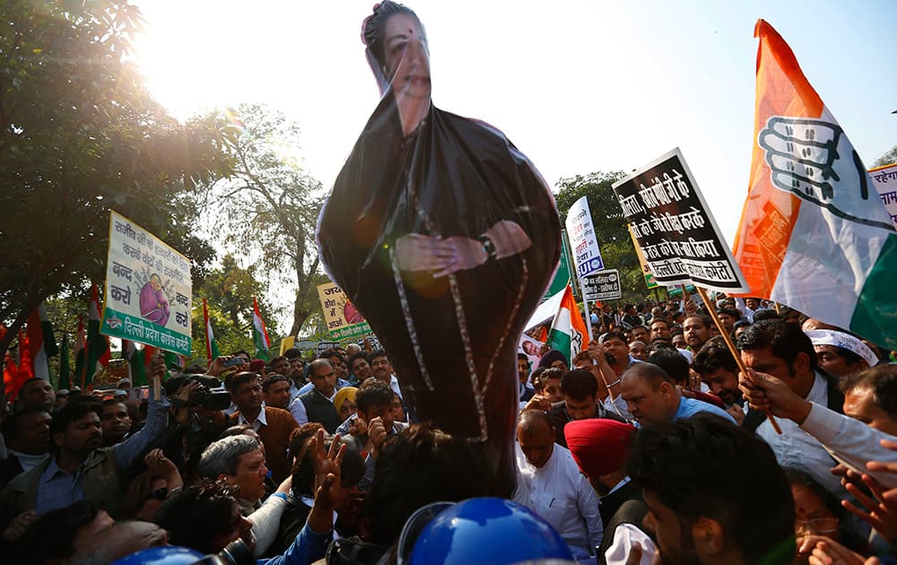 Congress party supporters hoist an effigy of the Chief Minister of the southern Indian state of Tamil Nadu Jayaram Jayalalitha as they protest against her outside Tamil Nadu state house in New Delhi.
