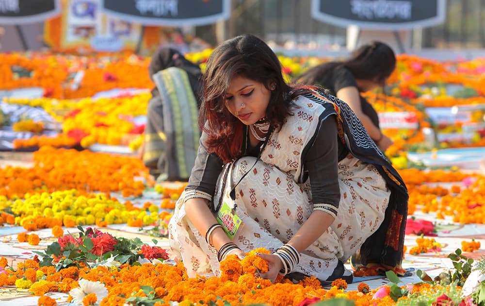 A Bangladeshi woman decorates the Shaheed Minar, or Martyr’s Monuments on International Mother Language Day in Dhaka, Bangladesh.