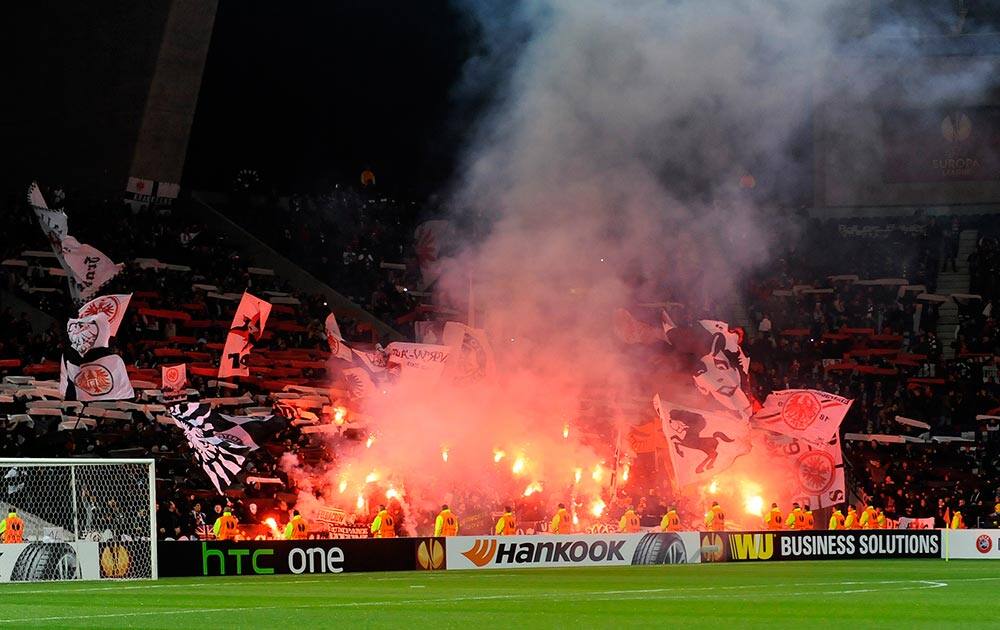 Eintracht Frankfurt`s fans light flares prior to their 2-2 draw against FC Porto during their Europa League round of 32, first leg soccer match at the Dragao stadium, in Porto, Portugal.