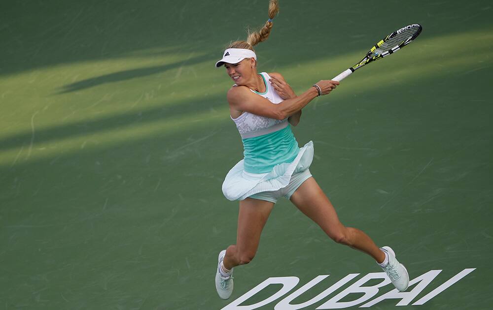 Caroline Wozniacki of Denmark returns the ball to Sorana Cirstea of Romania during the quarterfinals of the Dubai Duty Free Tennis Championships in Dubai, United Arab Emirates.