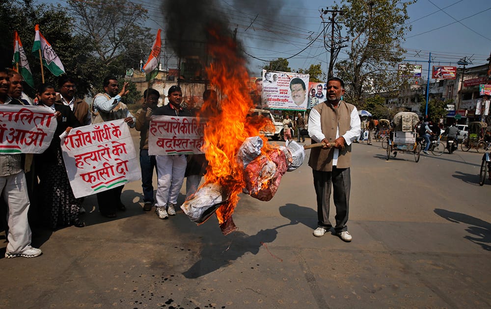 India’s ruling Congress party supporters burn an effigy of Tamil Nadu state chief minister Jayaram Jayalalitha during a protest in Allahabad.