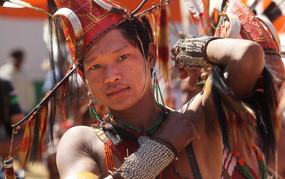 A member of Indigenous Tusta tribe of India’s north-eastern Arunachal Pradesh state in traditional attire waits to perform a dance during the 28th statehood day celebrations in Itanagar.
