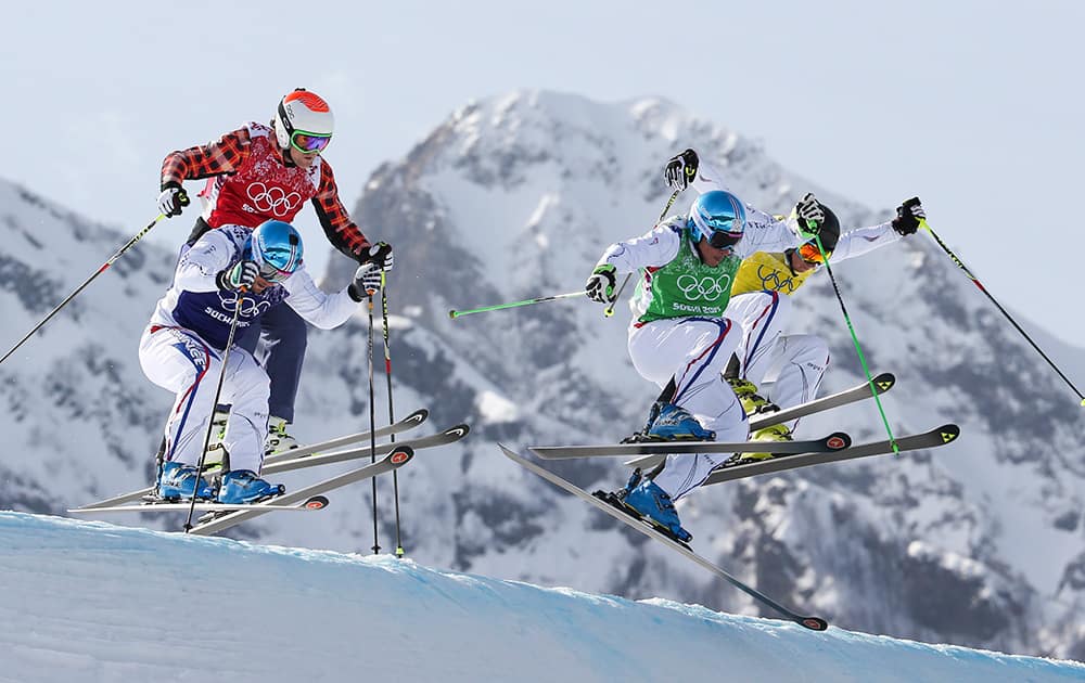 Jean Frederic Chapuis, front right, Arnaud Bovolenta, front left, Jonathan Midol, all of France, background right, and Brady Leman of Canada, background left, compete in the men`s ski cross final at the Rosa Khutor Extreme Park, at the 2014 Winter Olympic in Krasnaya Polyana, Russia.