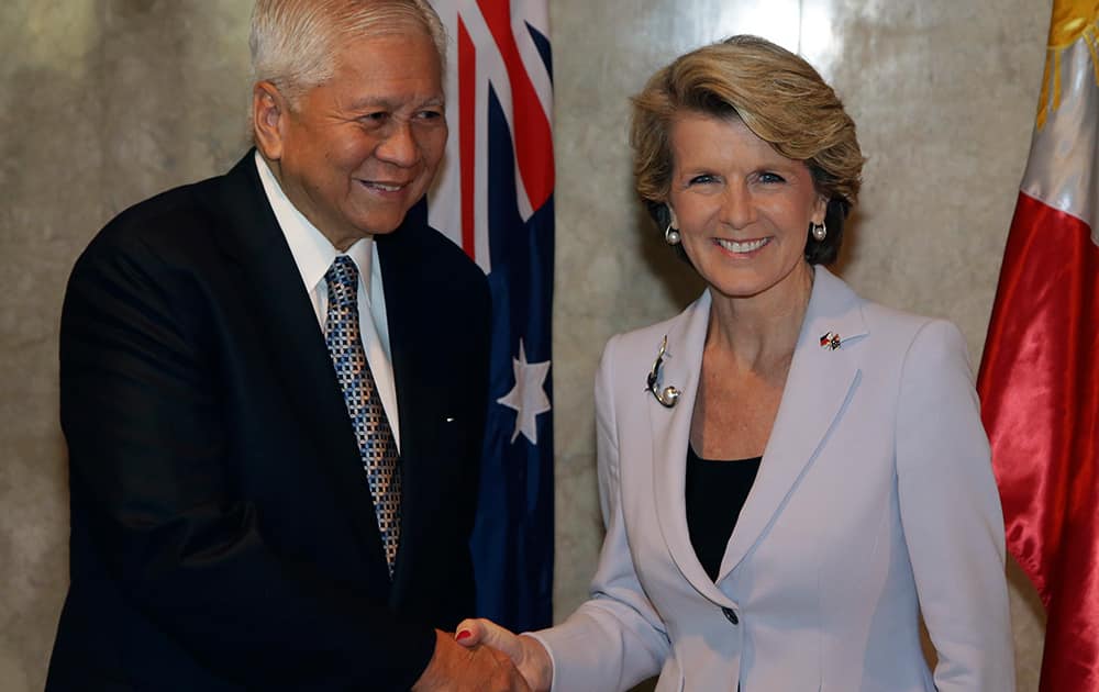 Philippine Foreign Secretary Albert del Rosario shakes hands with Australian Foreign Minister Julie Bishop as she arrives at the Department of Foreign Affairs in Manila, Philippines.