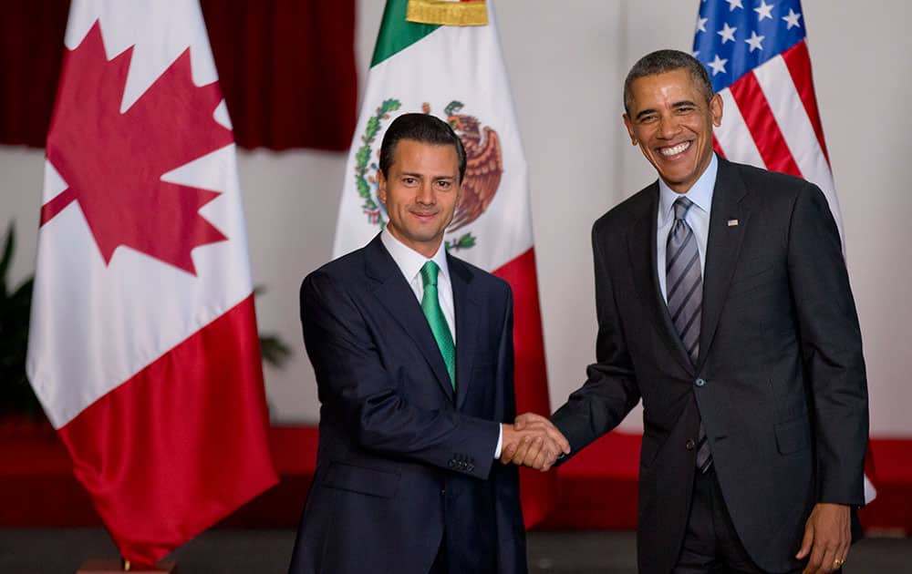 Mexico`s President Enrique Pena Nieto, left, and President Barack Obama pose for photographers at the North American Leaders Summit in Toluca, Mexico.