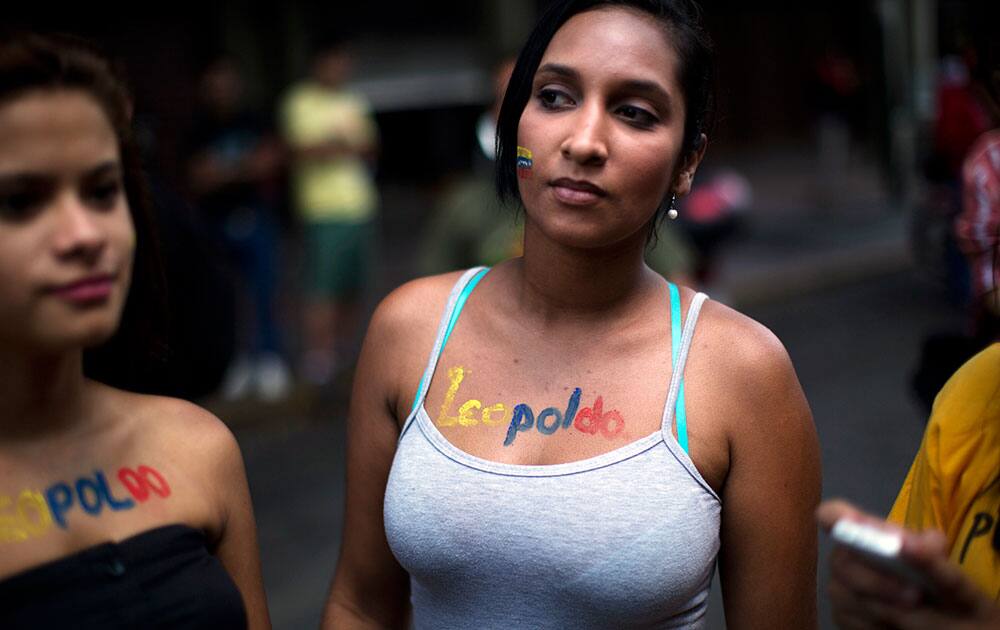 Supporters of opposition leader Leopoldo Lopez stand outside the Palace of Justice court in Caracas, Venezuela.