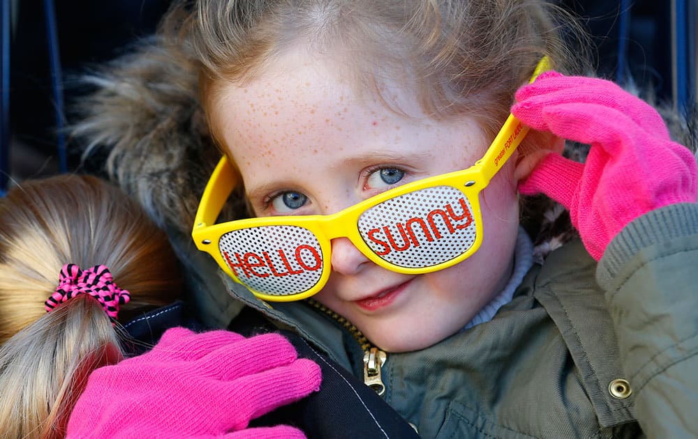 Mia Heagney wears her `Hello Sunny` sun glasses during the Hello Sunny beach promotion, hosted by the Greater Fort Lauderdale Convention & Visitors Bureau in Tribune Plaza, in Chicago.