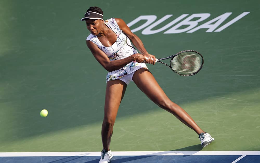 Venus Williams of the U.S. returns the ball to Ana Ivanovic of Serbia during the third day of Dubai Duty Free Tennis Championships in Dubai, United Arab Emirates.