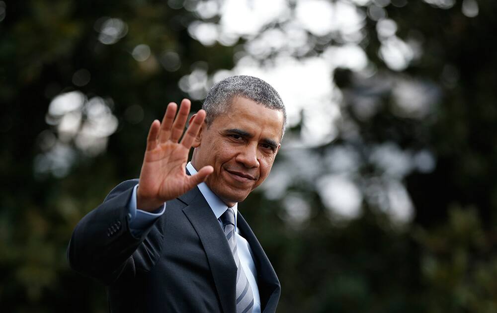 President Barack Obama waves to reporters as he walks on the South Lawn of the White House in Washington as he boards Marine One helicopter to Andrews Air Force Base, Md., for his trip to Mexico.