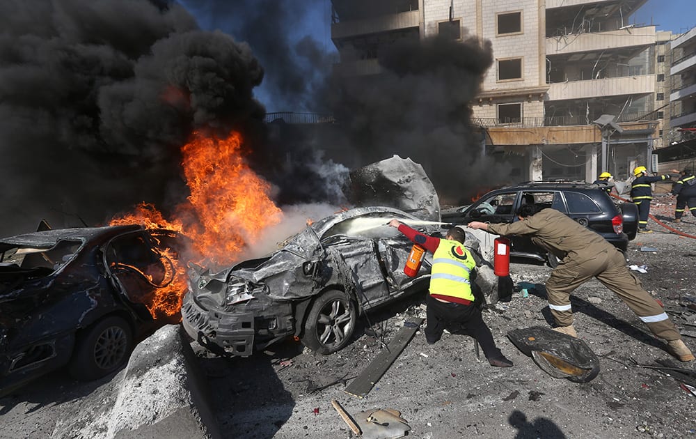 Lebanese firefighters extinguish burned cars at the site of an explosion, near the Kuwaiti Embassy and Iran`s cultural center, in the suburb of Beir Hassan, Beirut, Lebanon.