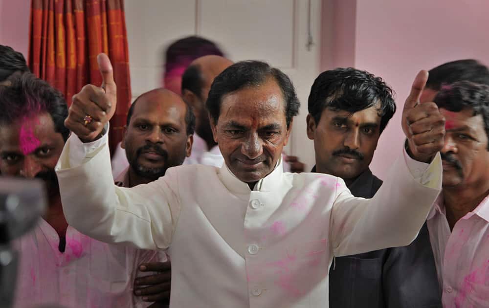 Telangana Rashtra Samithi (TRS) party president K. Chandrashekar Rao shows a thumbs up sign to supporters after the Indian parliament’s lower house passed the bill for the creation of new state called ‘Telangana’ in New Delhi.