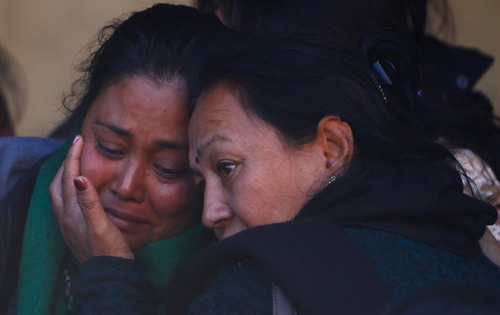 Family members of the plane crash victims cry at Teaching hospital in Katmandu, Nepal. Rescuers in Nepal on Monday found the wreckage of a passenger plane that slammed into a snow-covered mountain and burst into flames, killing all 18 people on board, including a small child, authorities said.