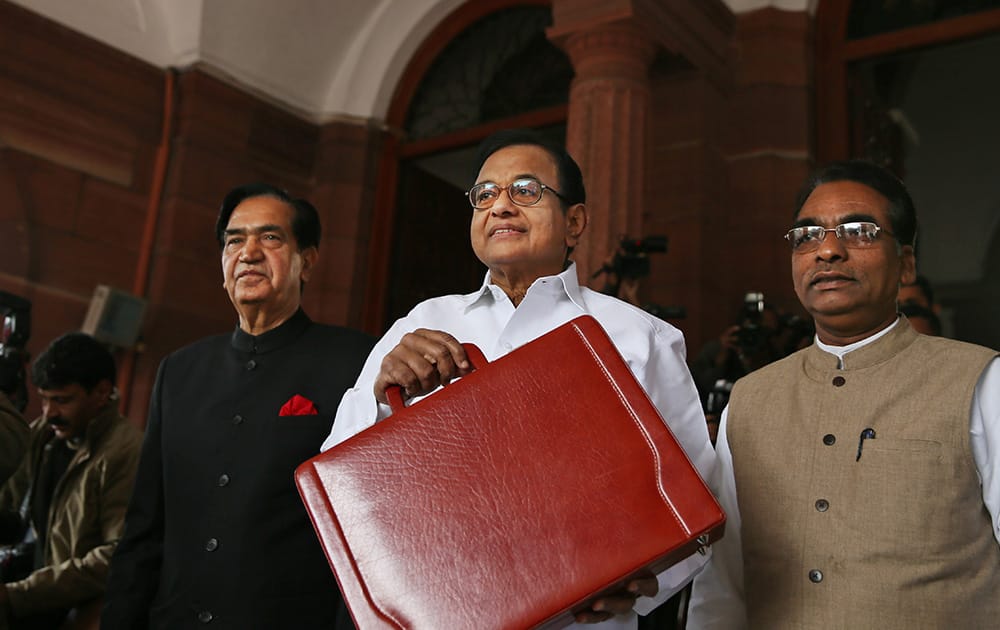 Finance Minister P. Chidambaram shows a briefcase containing interim budget for the fiscal year 2014-15 at parliament in New Delhi.