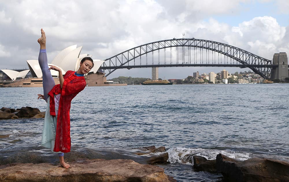 Chinese ballet star Zhang Yashu poses for photos in front of the Opera House and Harbour Bridge during a photo call in Sydney. The 150-member China Wuxi Performing Arts Group will perform