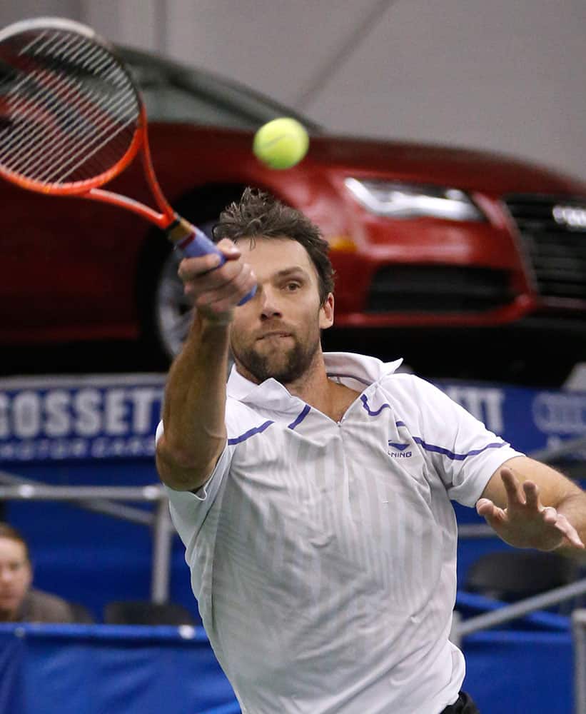 Ivo Karlovic, of Croatia, stretches to return a high ball to Lu Yen-hsun, of Taiwan, at the semifinals of the U.S. National Indoor Tennis Championships in Memphis, Tenn.