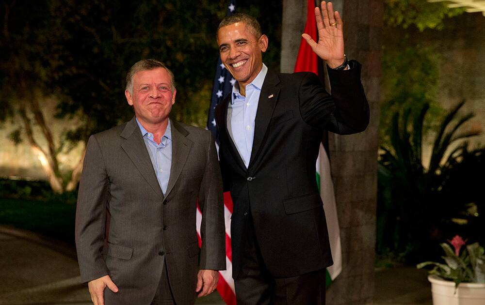 President Barack Obama waves to the media as he greets Jordan`s King Abdullah II at The Annenberg Retreat at Sunnylands, Rancho Mirage, Calif.