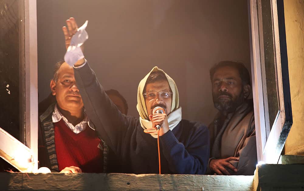 Anti-graft activist Arvind Kejriwal, center, addresses his supporters with resignation letter in his hand at Aam Aadmi Party, or Common Man’s Party, headquarters in New Delhi, India.