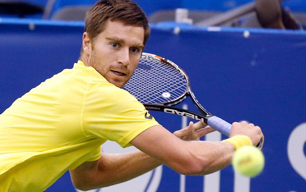 Alex Kuznetsov. of the United States, prepares to hit a return to Lu Yen-Hsun, of Taiwan, in the quarterfinals at the US National Indoor Tennis Championships.