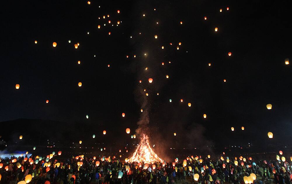 Residents release paper lanterns into the air to celebrate the first full moon of the Lunar New Year, in Yongin, South Korea.