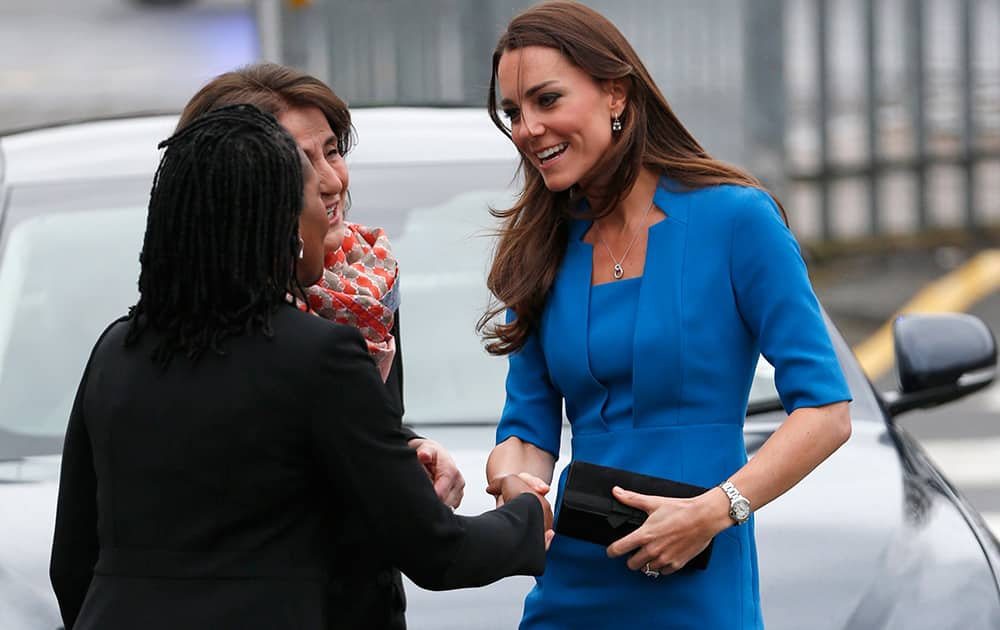 Britain`s Duchess of Cambridge is greeted as she arrives to attend the Art Room opening at Northolt High School, in west London.
