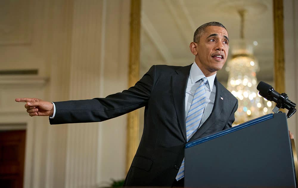 President Barack Obama gestures in the East Room of the White House in Washington, before signing an executive order to raise the minimum wage for federal contract workers.