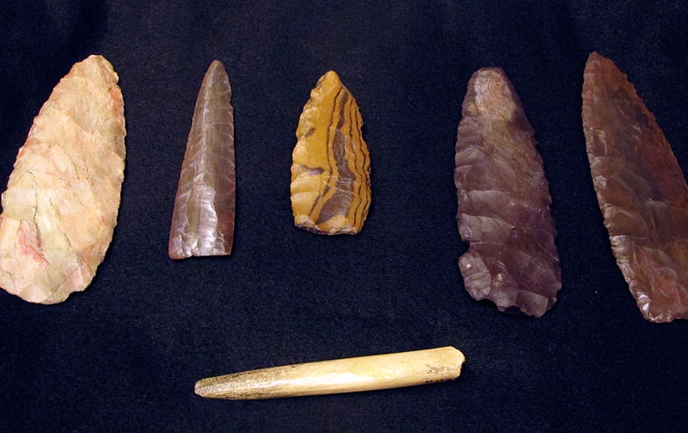 Replicas of artifacts discovered at a site at least 12,600 years old are displayed at the Montana Historical Society in Helena, Mont.