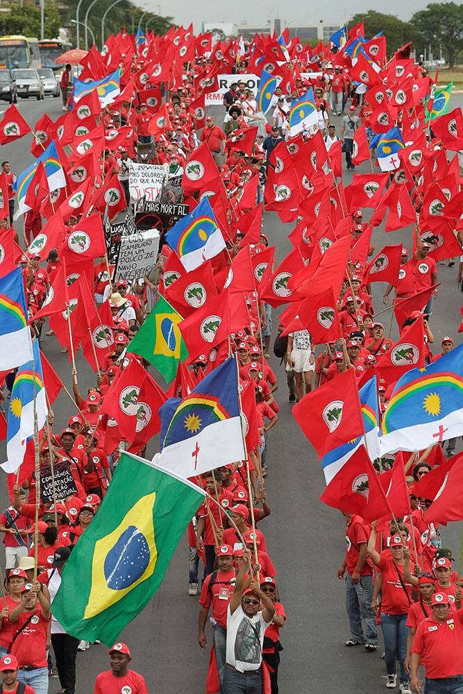 Demonstrators participate in a march organized by the Rural Workers Landless Movement or MST, most waving the red MST banners along with Brazilian national flags and Pernambuco state flags, in Brasilia, Brazil.