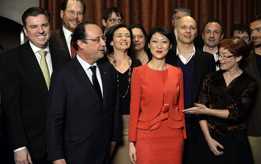 French President Francois Hollande and Minister Delegate with responsibility for Small and Medium Enterprises, Innovation, and the Digital Economy Fleur Pellerin, second from right, talk with business leaders at the restaurant