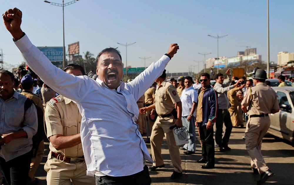 A member of Maharashtra Navnirman Sena (MNS) shouts slogans as he is detained by a policeman during a protest in Mumbai. MNS has announced statewide road blocks to protest against toll collection in the state.