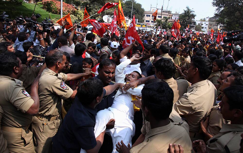 Police detain activists of Greater Hyderabad Municipal Corporation (GHMC) during a protest organized by all trade unions in Hyderabad.
