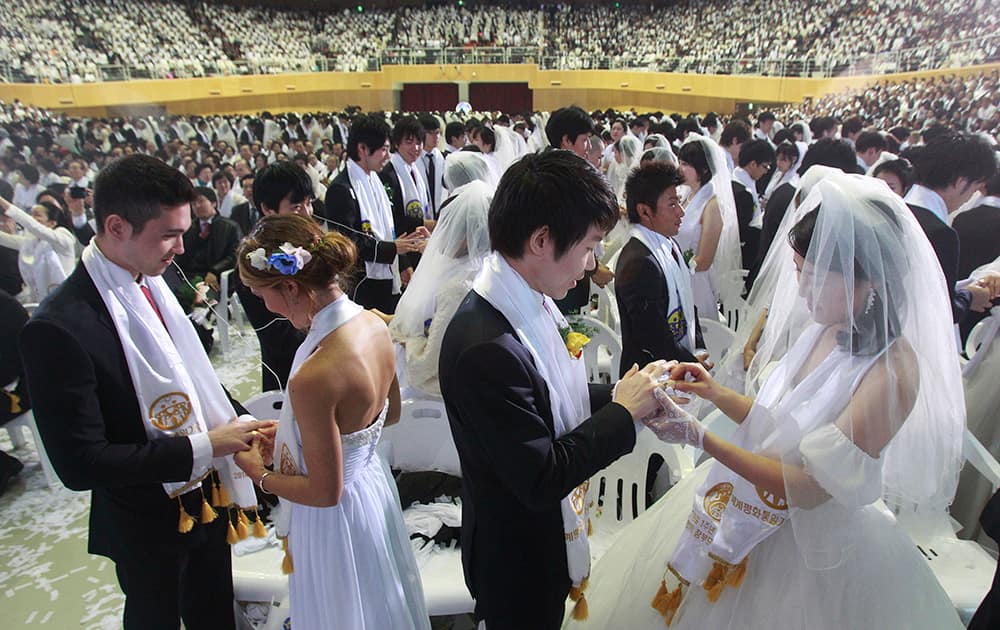 Couples from around the world exchange their rings in a mass wedding ceremony at the CheongShim Peace World Center in Gapyeong, South Korea.
