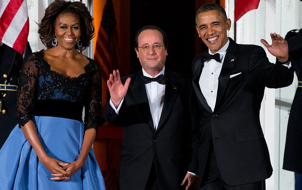 First lady Michelle Obama, left, and President Barack Obama welcome French President François Hollande for a State Dinner at the North Portico of the White House in Washington.