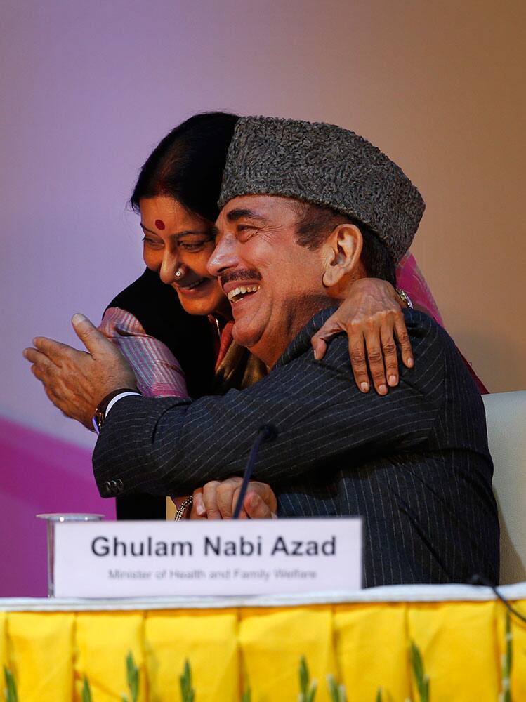 Leader of India`s main opposition Bharatiya Janata Party (BJP) Sushma Swaraj embraces Health Minister Ghulam Nabi Azad, right, at a function to celebrate the third year after India was declared polio free in New Delhi, India.