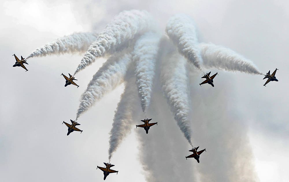 The T-50 jets of Republic of Korea Air Force aerobatics team, the Black Eagles, perform a maneuver in the aerial display on the first day of the Singapore Air Show.