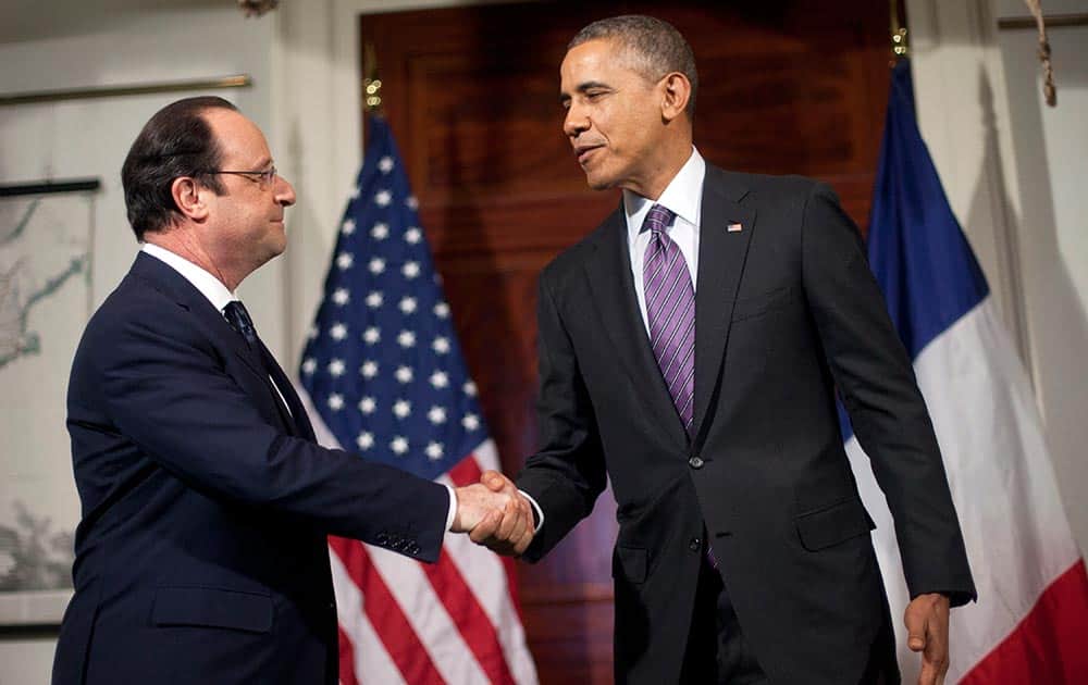 President Barack Obama and French President Francois Hollande, shake hands after talking with the media following their tour of Monticello, President Thomas Jefferson’s estate, in Charlottesville, Va.